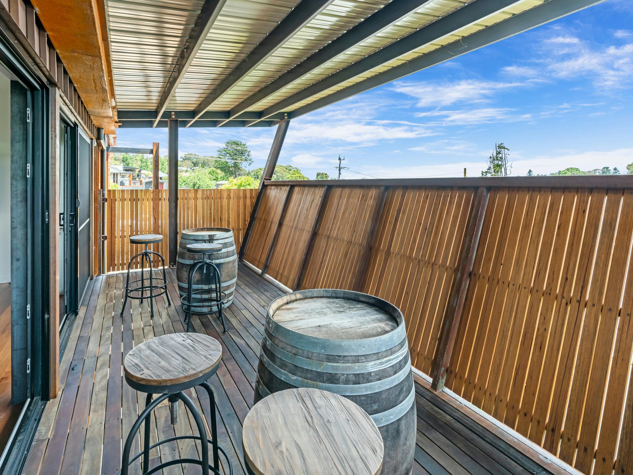 Upstairs balcony with local wine barrels and stools with a view over picturesque Beechworth