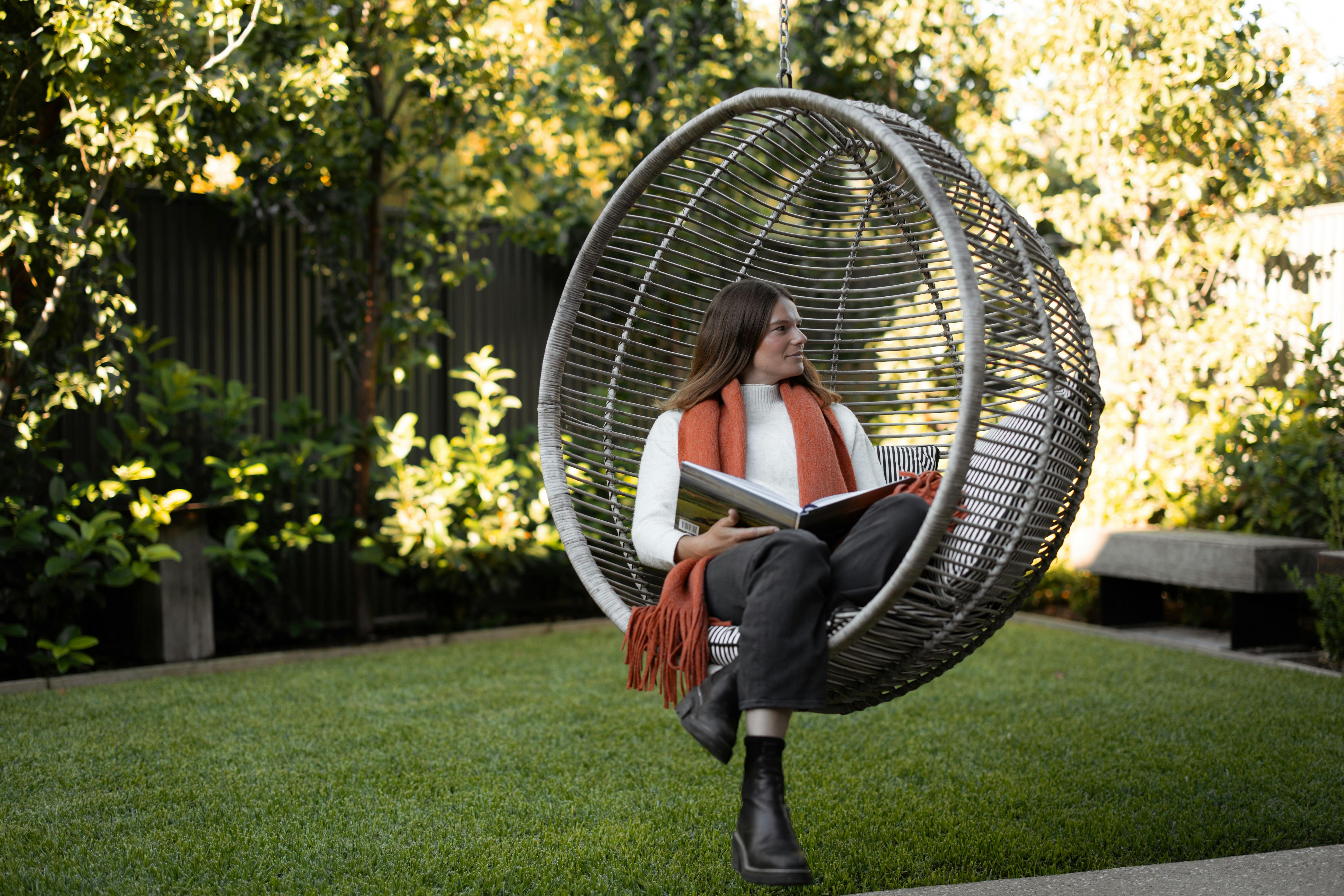 Woman sitting in hanging chair in a garden at Vale 194 McLaren Vale
