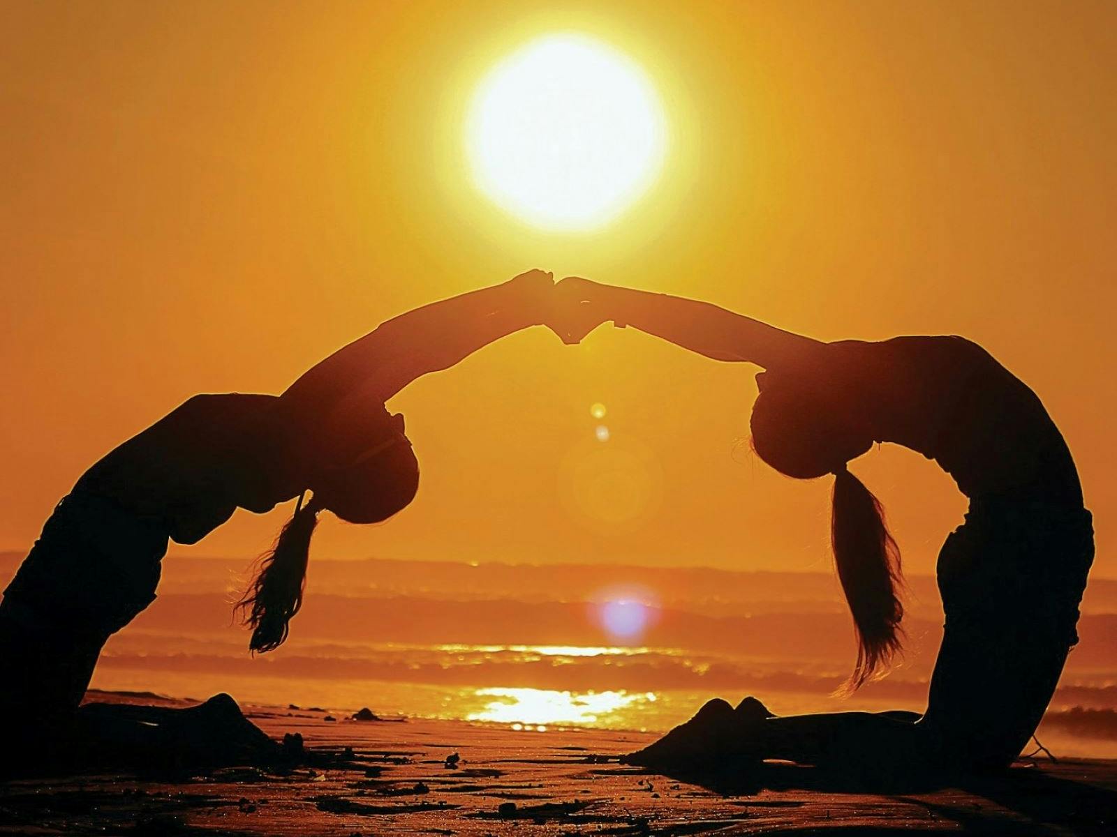 Yoga posing at sunset
