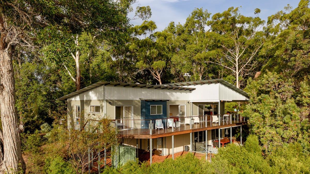 Expansive 18m entertaining deck with outdoor dining and seating, positioned for spectacular views