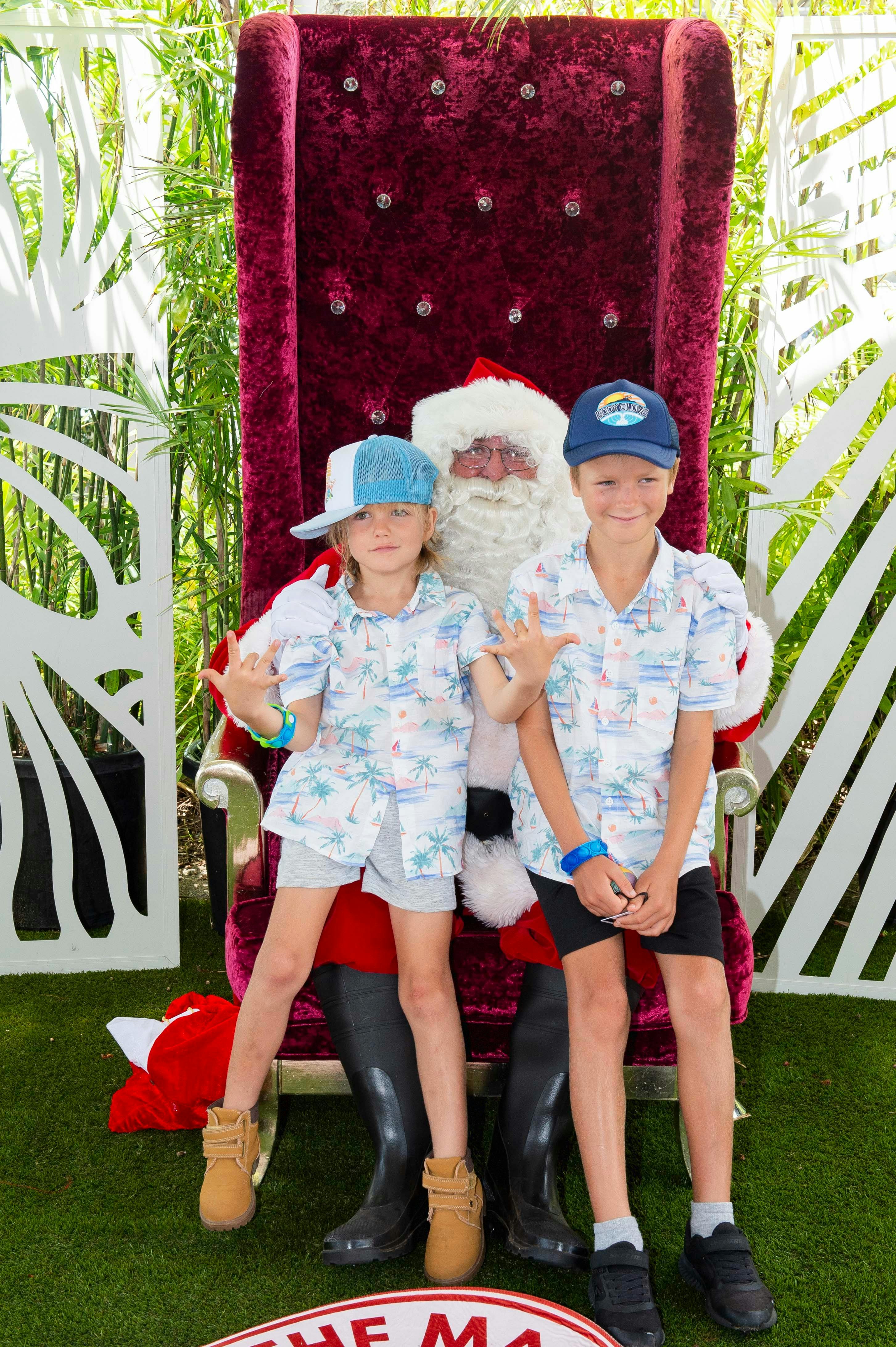2 kids sitting on santa's knee