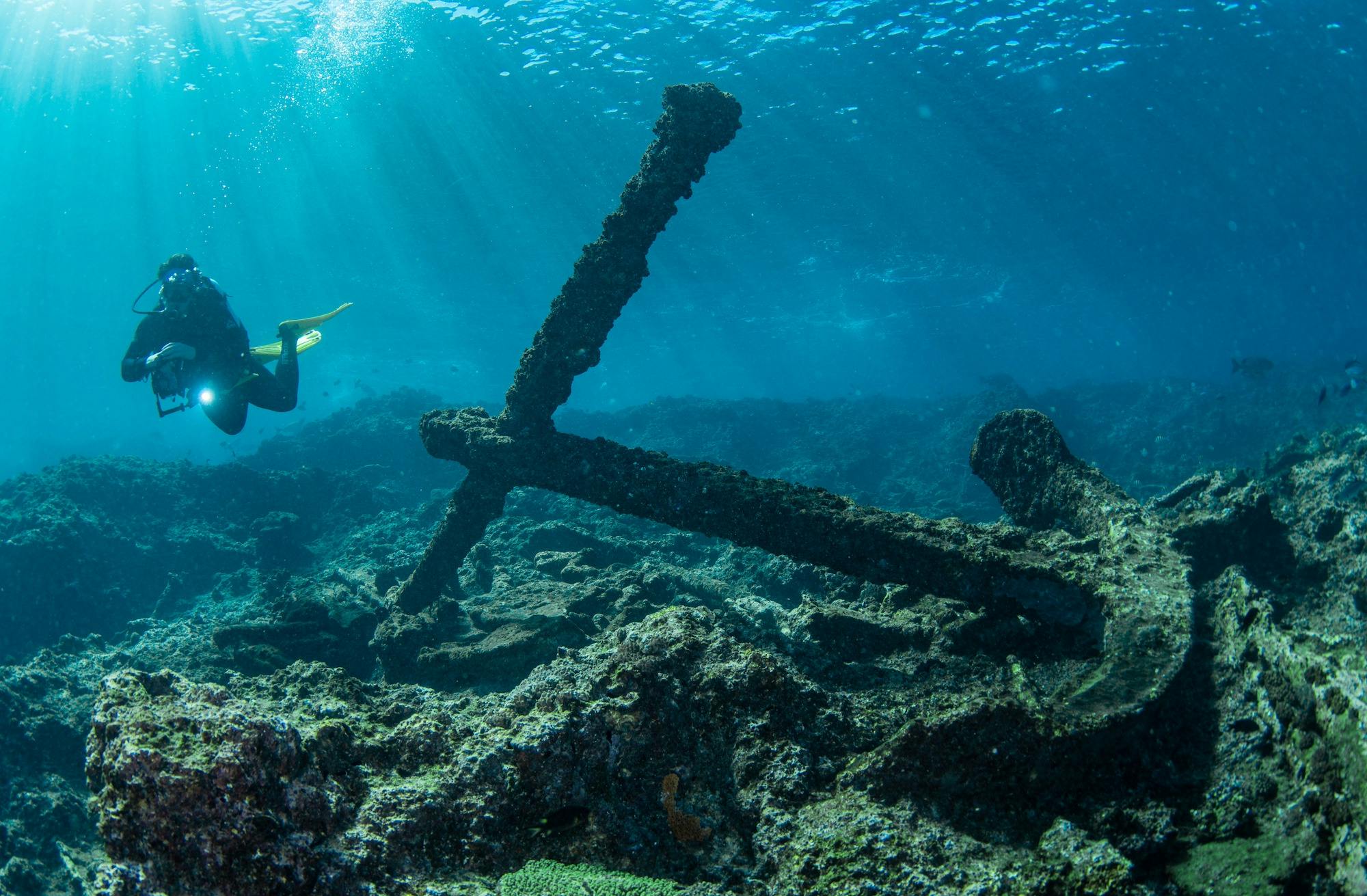 A Sail Ningaloo scuba diver next to an old anchor