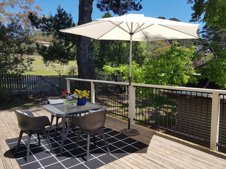 Blue Mountains guesthouse sunny back verandah with shady umbrella