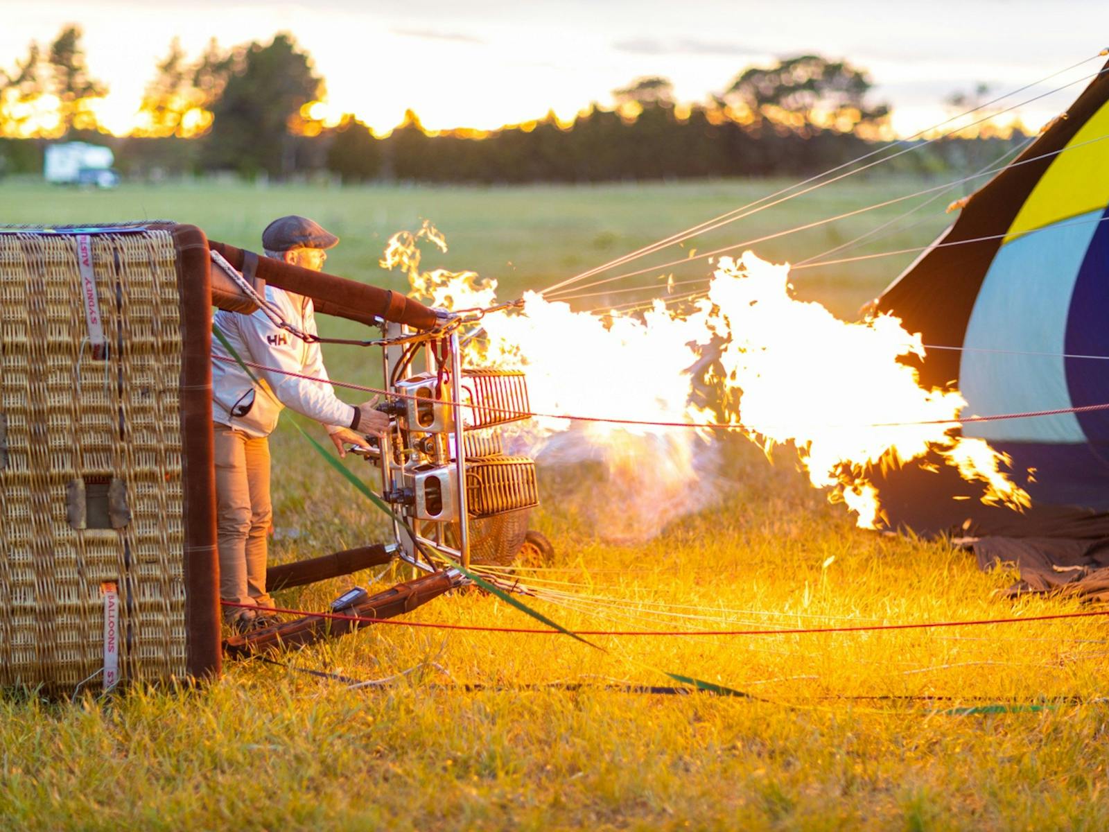 The balloon burner heats the air in the cold inflated "envelope " and making the balloon rise .