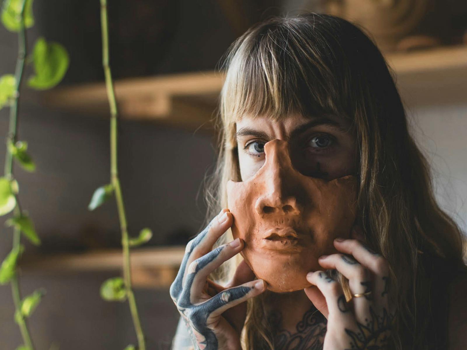 Person with clay mask