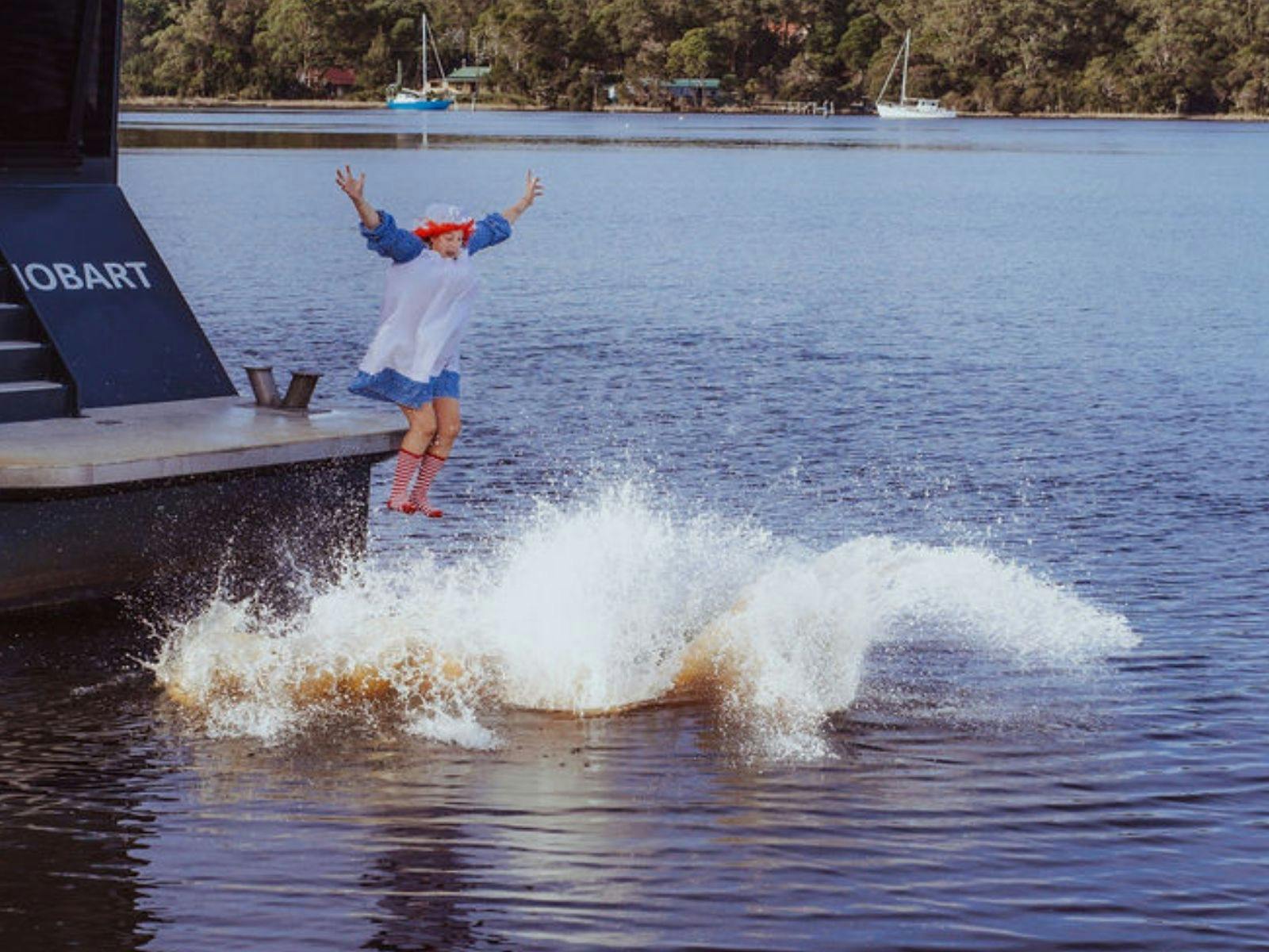 People jumping off boat during the Strahan Solstice Plunge.