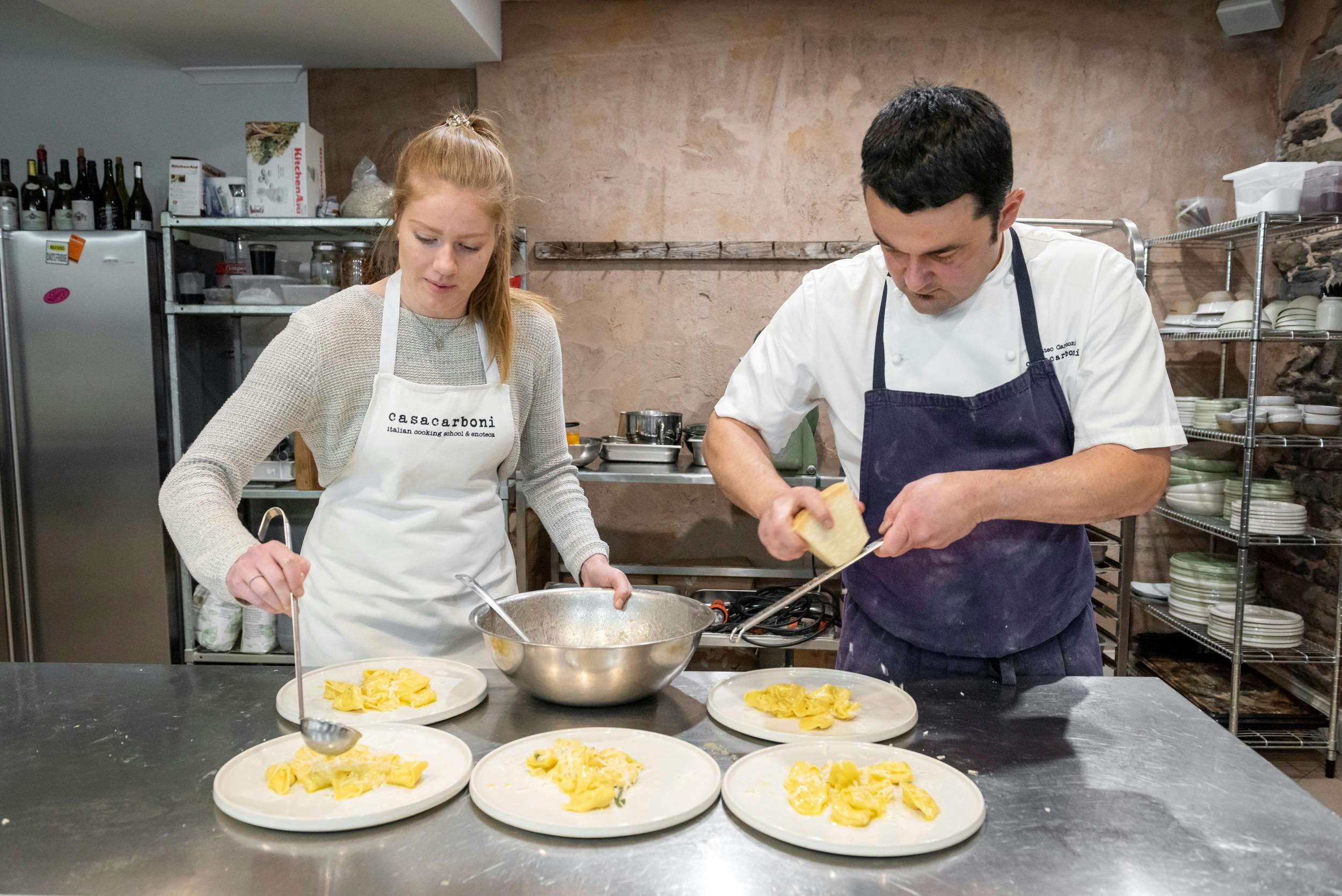Guests plating up freshly made ravioli for their lunch with chef Matteo Carboni