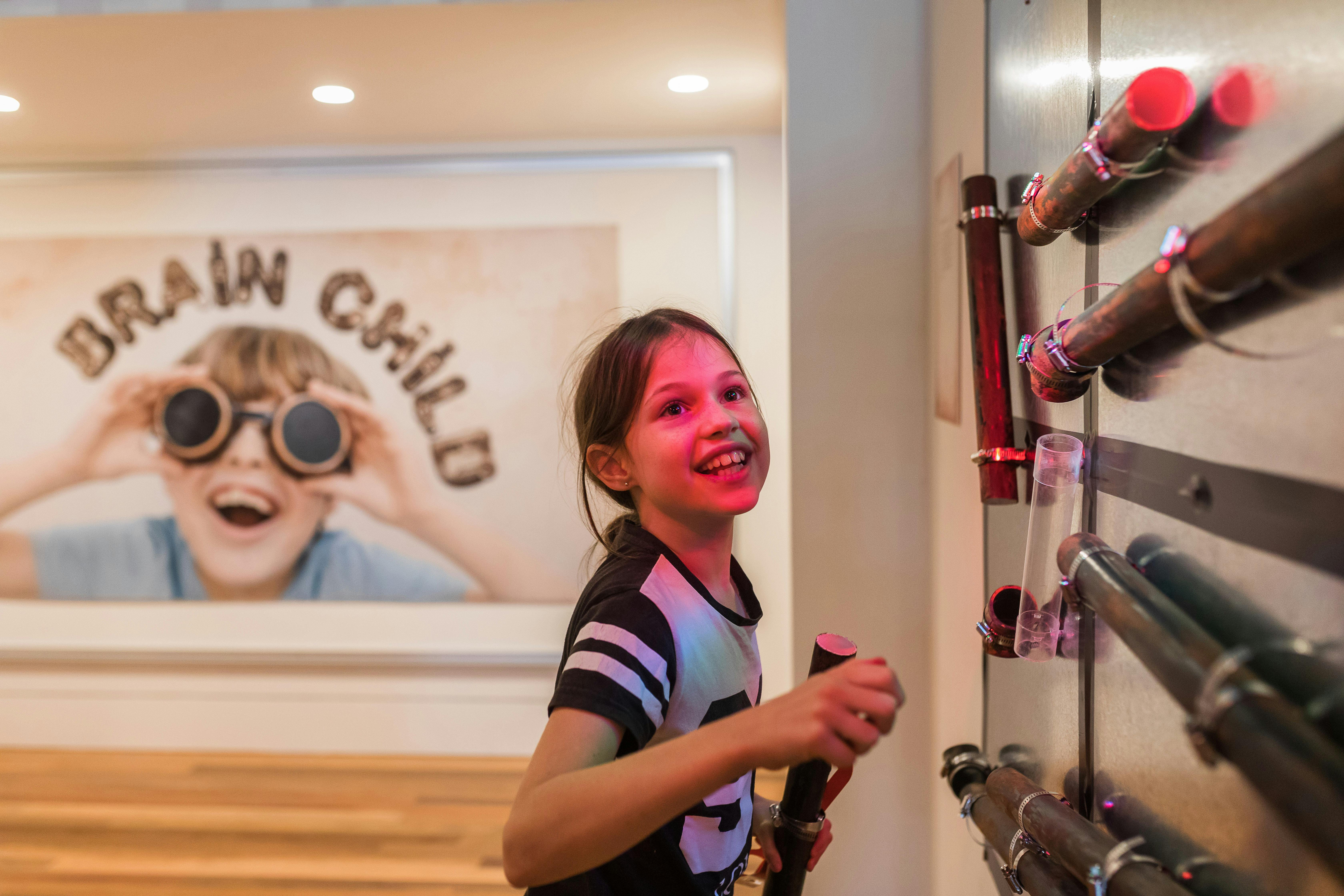 Young girl interacting with 'Brain child' children's  exhibition