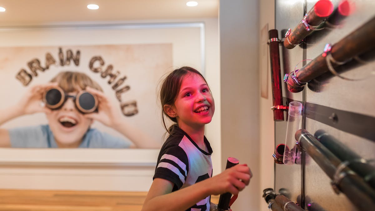 Young girl interacting with 'Brain child' children's  exhibition