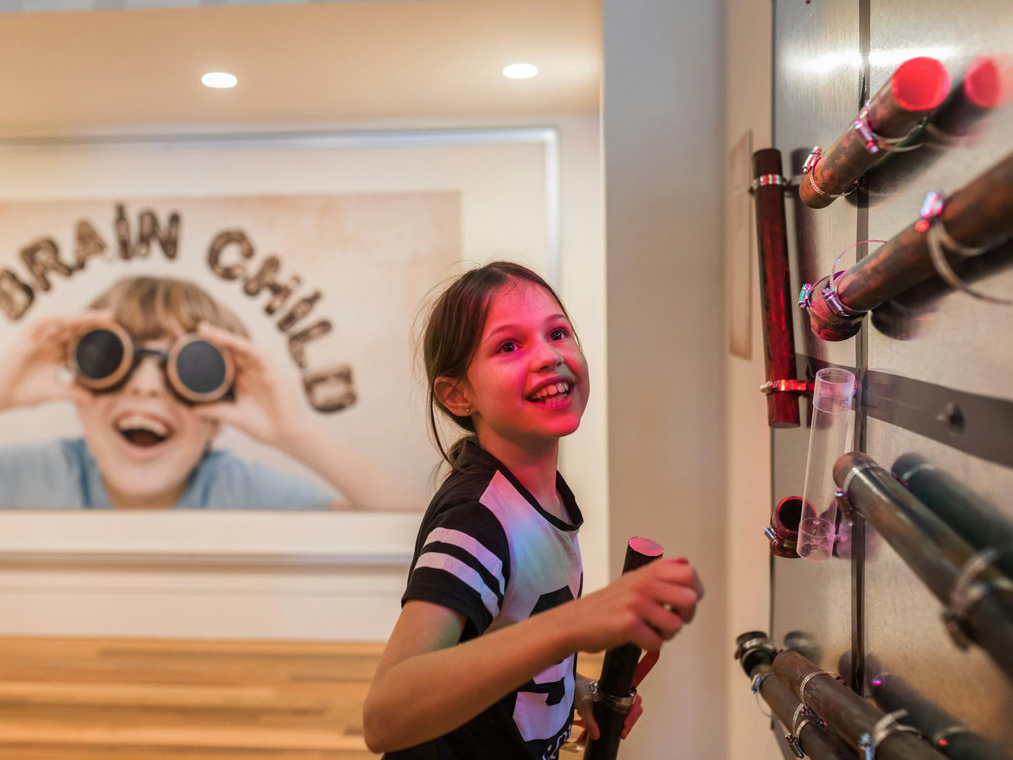 Young girl interacting with 'Brain child' children's  exhibition