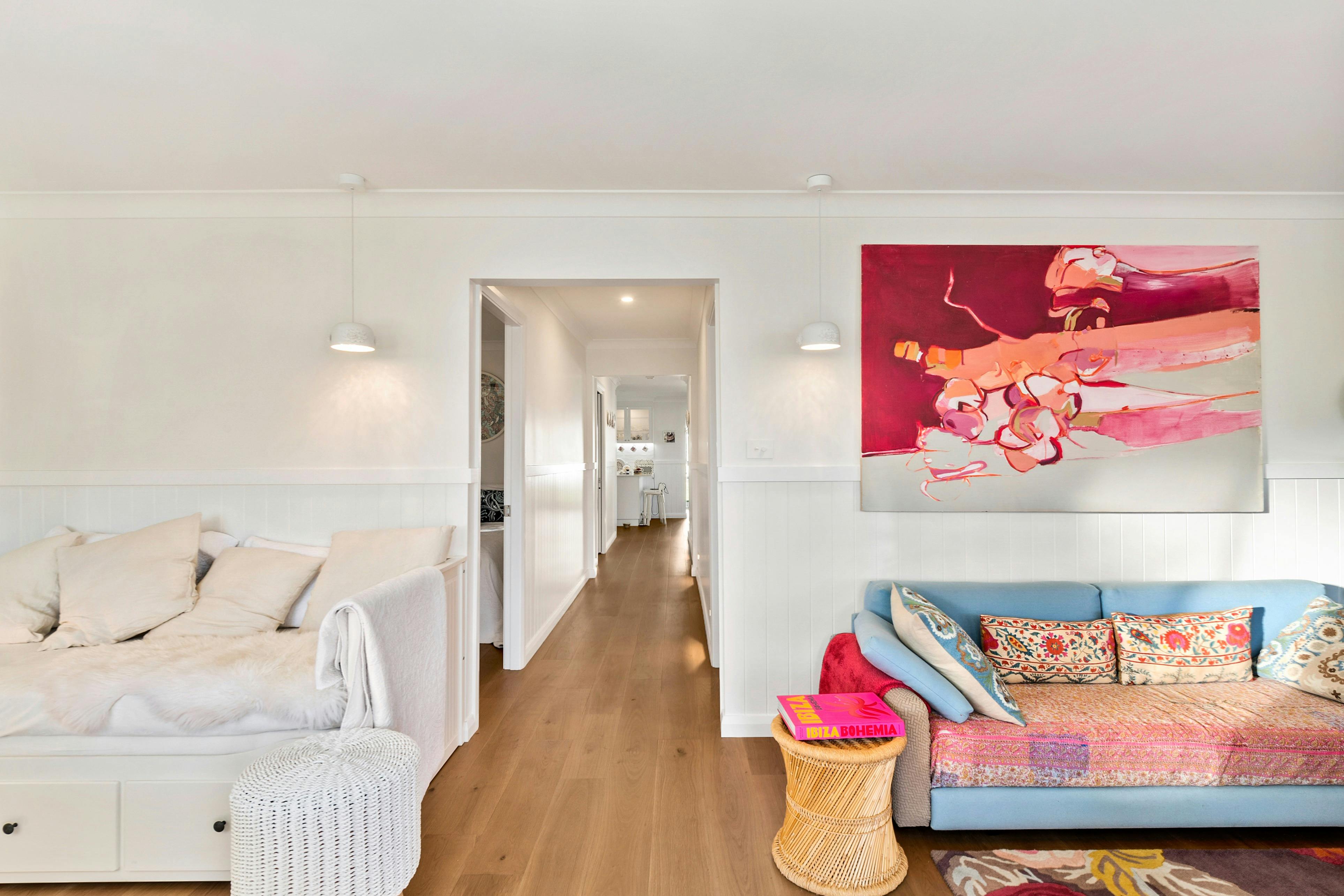 Bright living room at Lady Rose Cottage featuring lounge seating and large windows