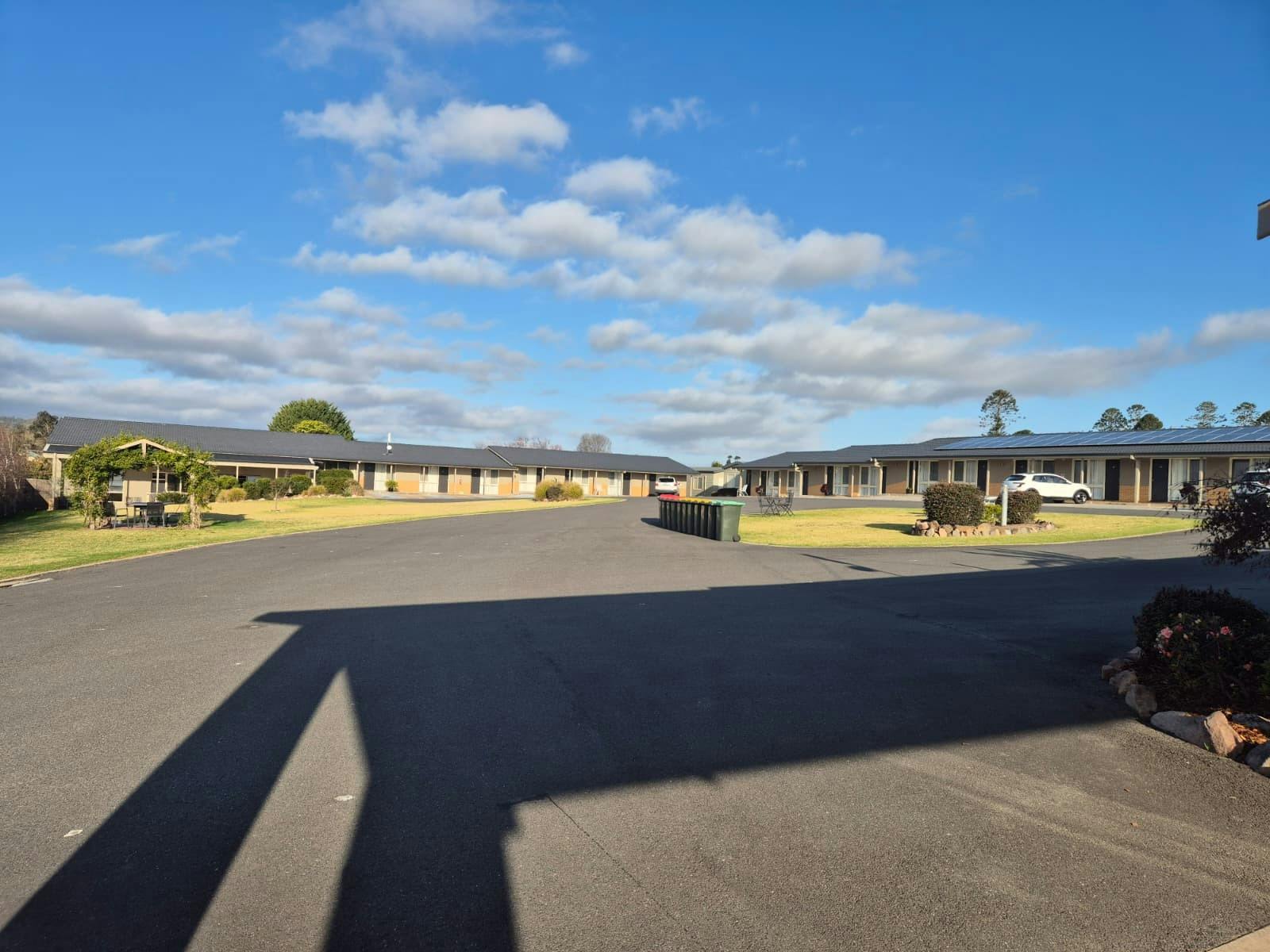 Exterior view of Bega Village Motor Inn, showcasing the well-maintained grounds, motel rooms and con