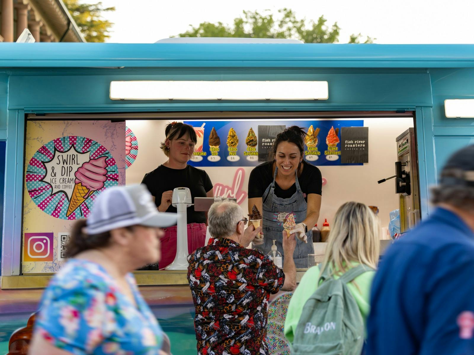 Customer being served an ice cream from the ice cream van.
