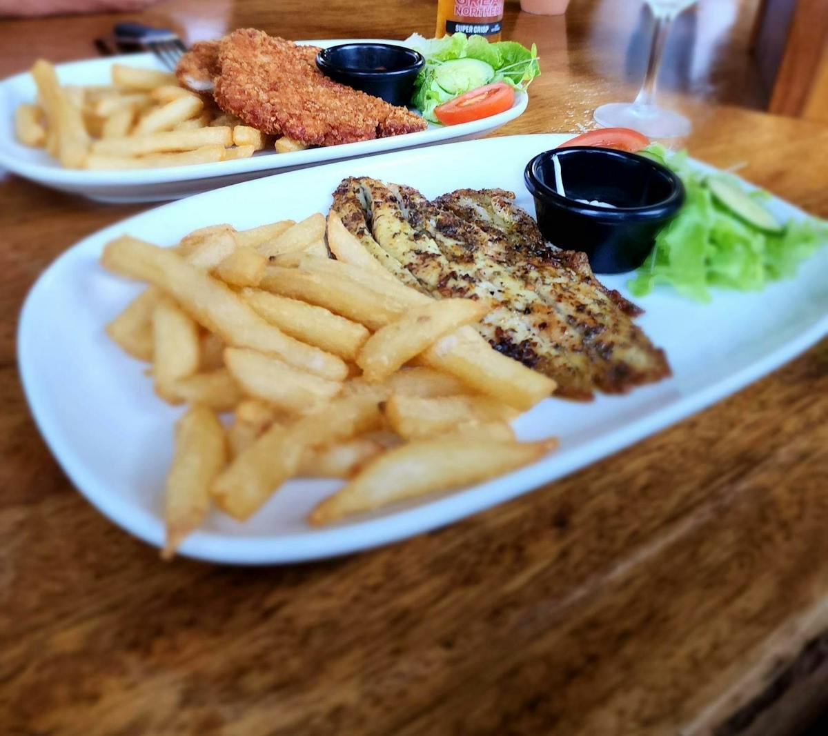 Daintree Siesta Restaurant - barramundi and chicken schnitzel main meals served with salad and chips