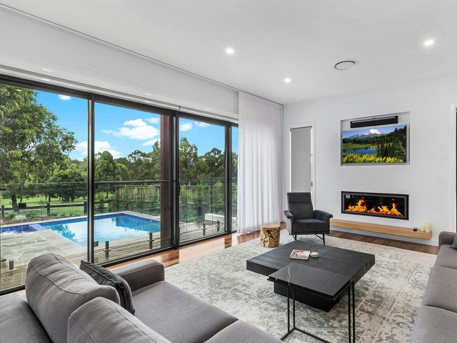 Villa Tallawanta lounge room with fireplace and pool area