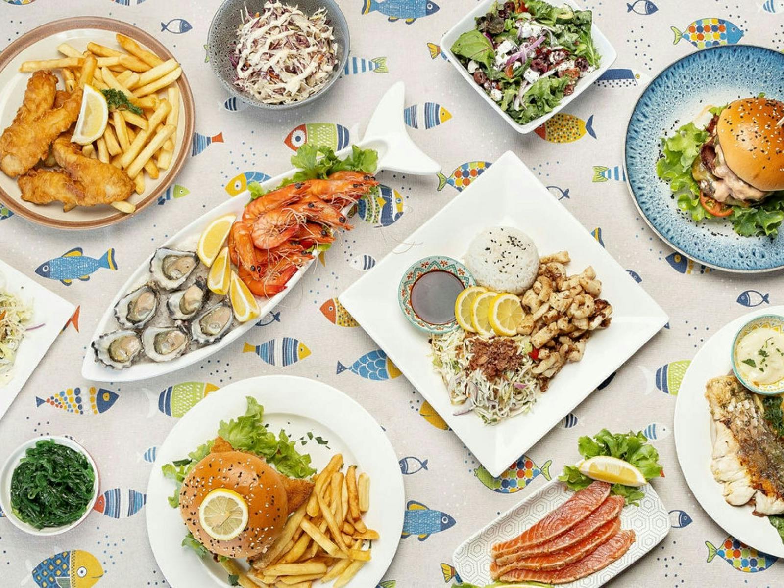Aerial view of table with plates of fresh seafood