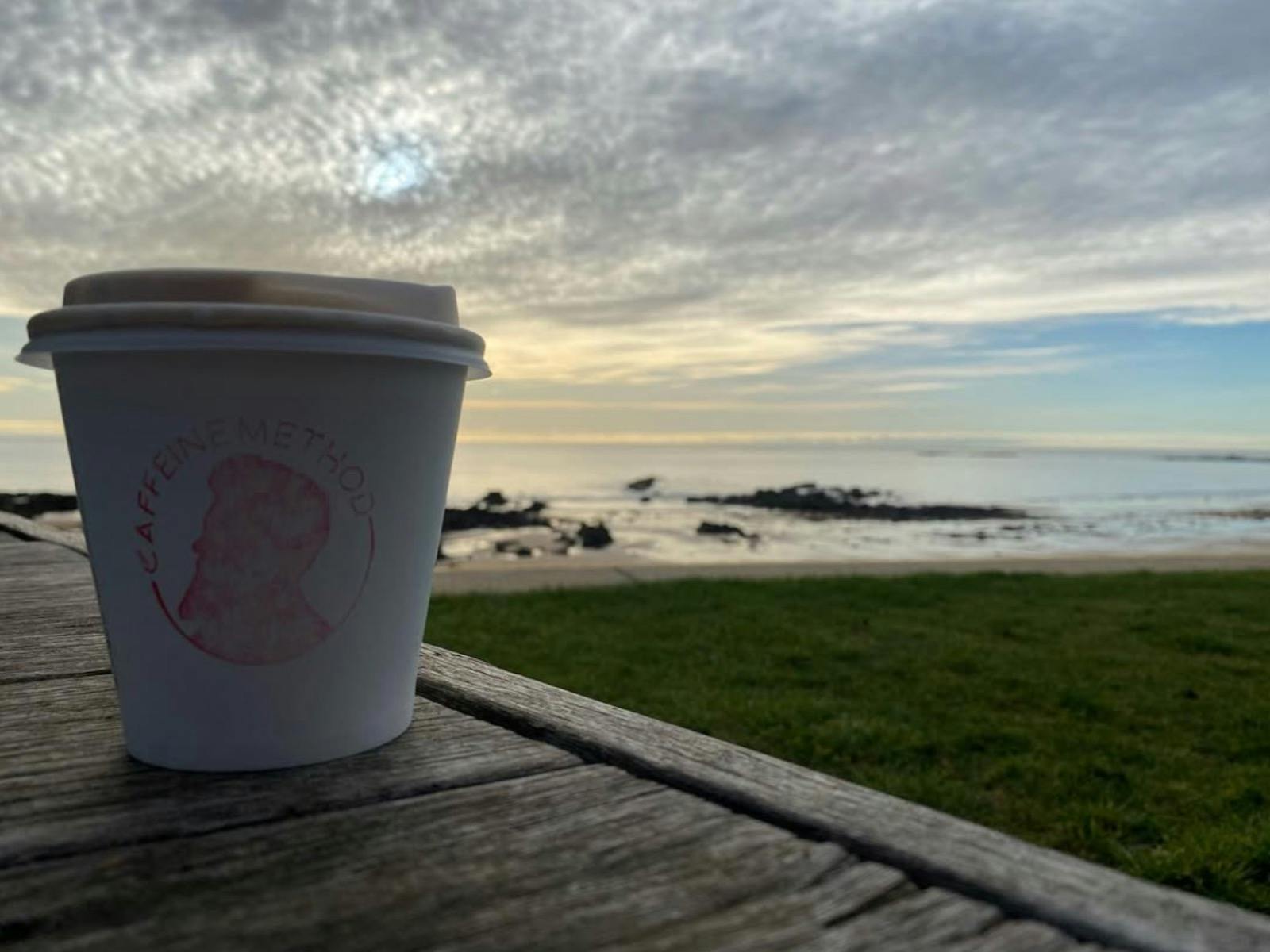 Takeaway coffee in front  of sunrise.