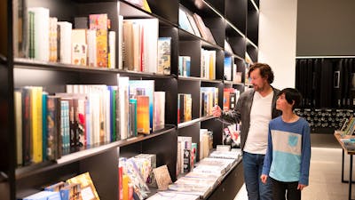 A father and son browsing books in the National Gallery Art Store
