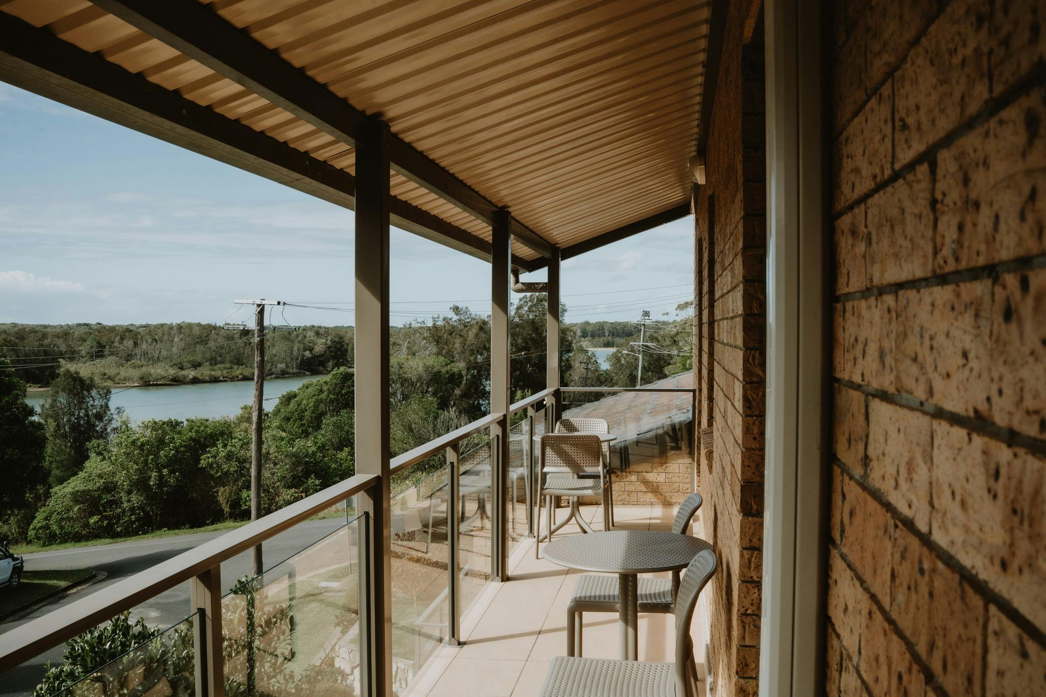 View of the Nambucca River from the balcony off the rooms, including outdoor dining furniture