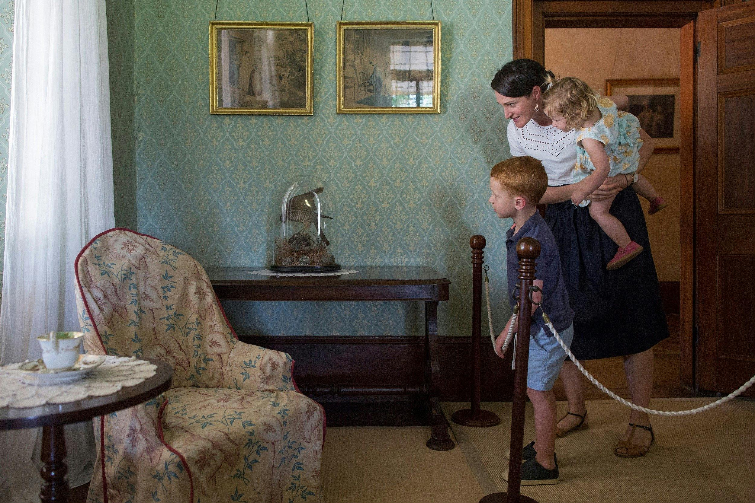 image of a mother and two children looking at furniture inside lanyon homestead