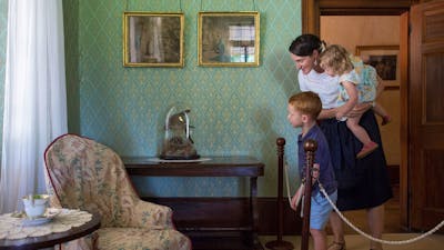 image of a mother and two children looking at furniture inside lanyon homestead