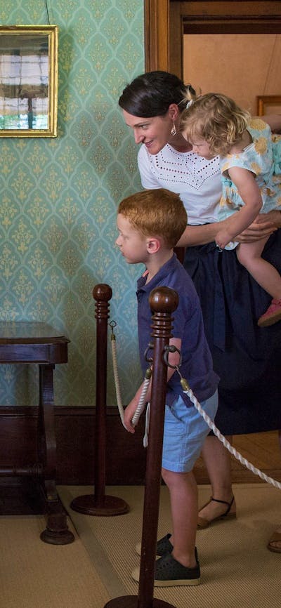image of a mother and two children looking at furniture inside lanyon homestead