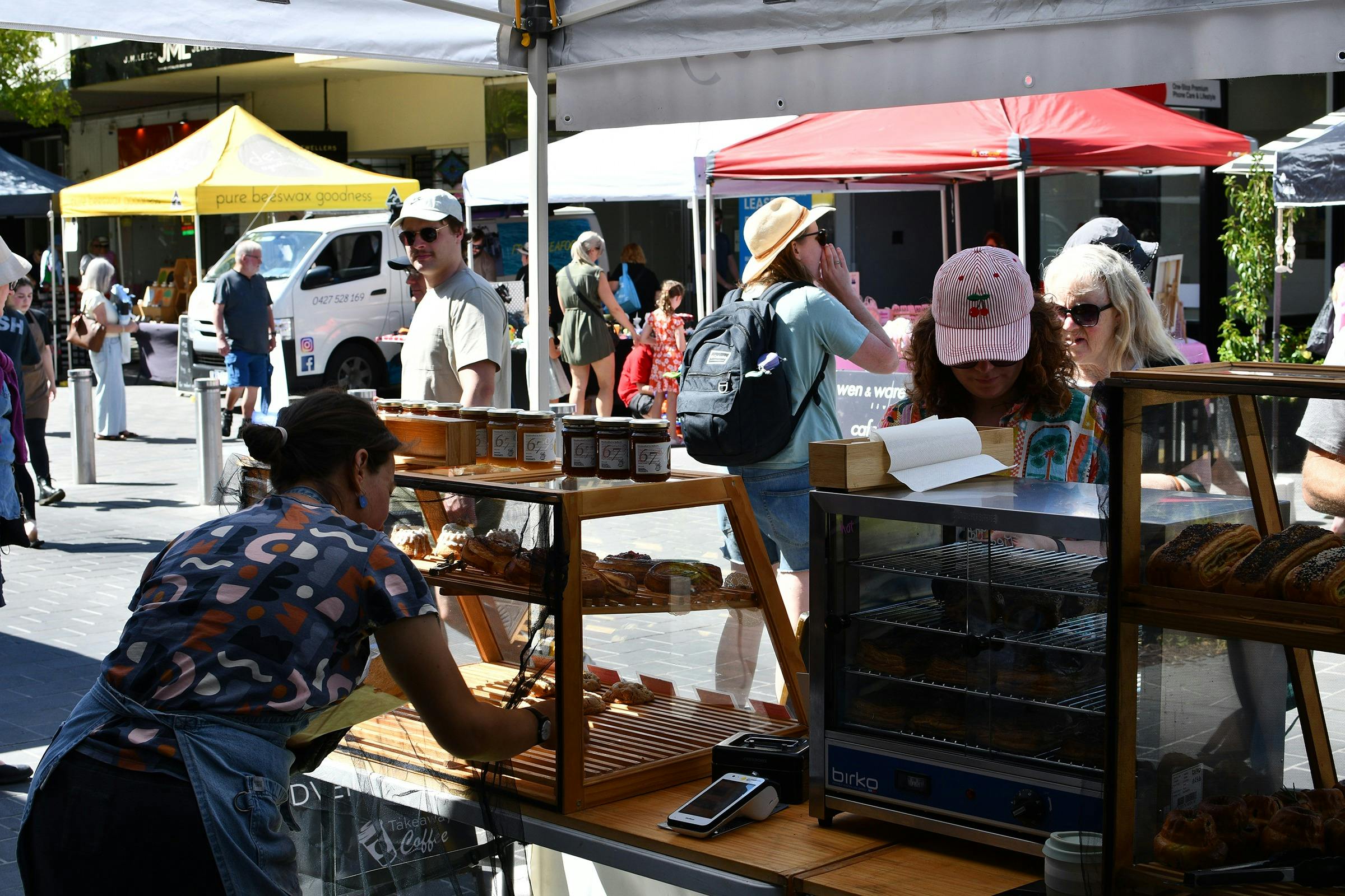 A stall holder arranging their goods