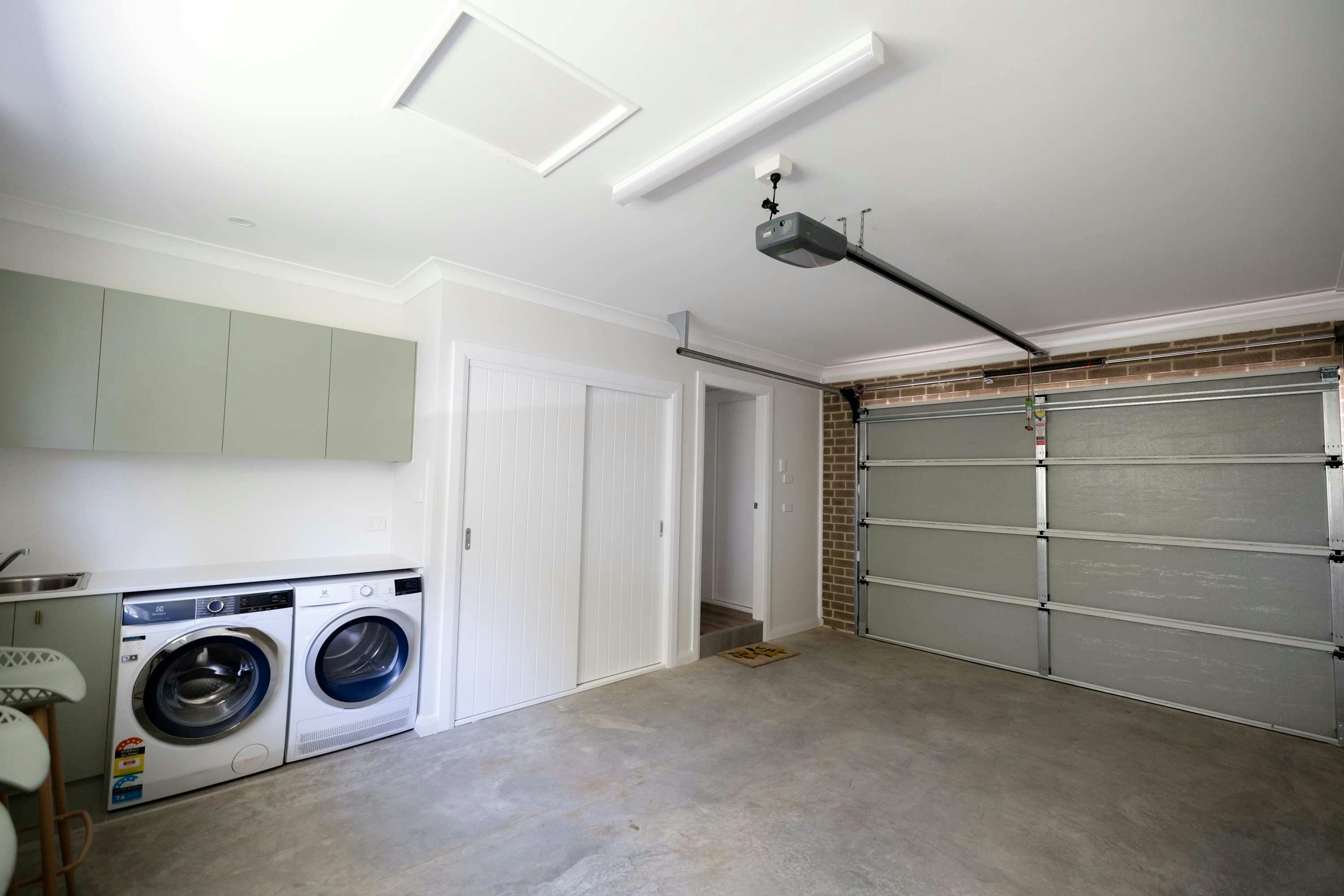 Laundry includes washer and dryer with an electric roller door for guests to park in the garage.