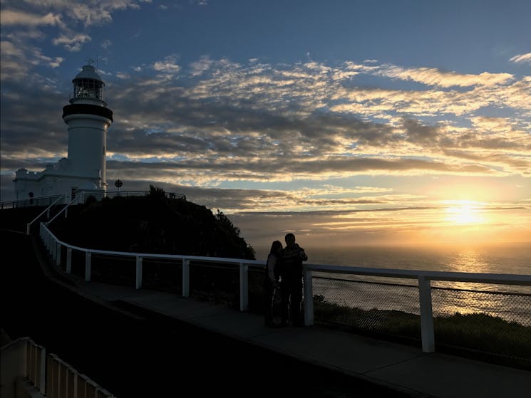 A couple enjoying a private moment watching Australia's first mainland sunrise at Cape Byron