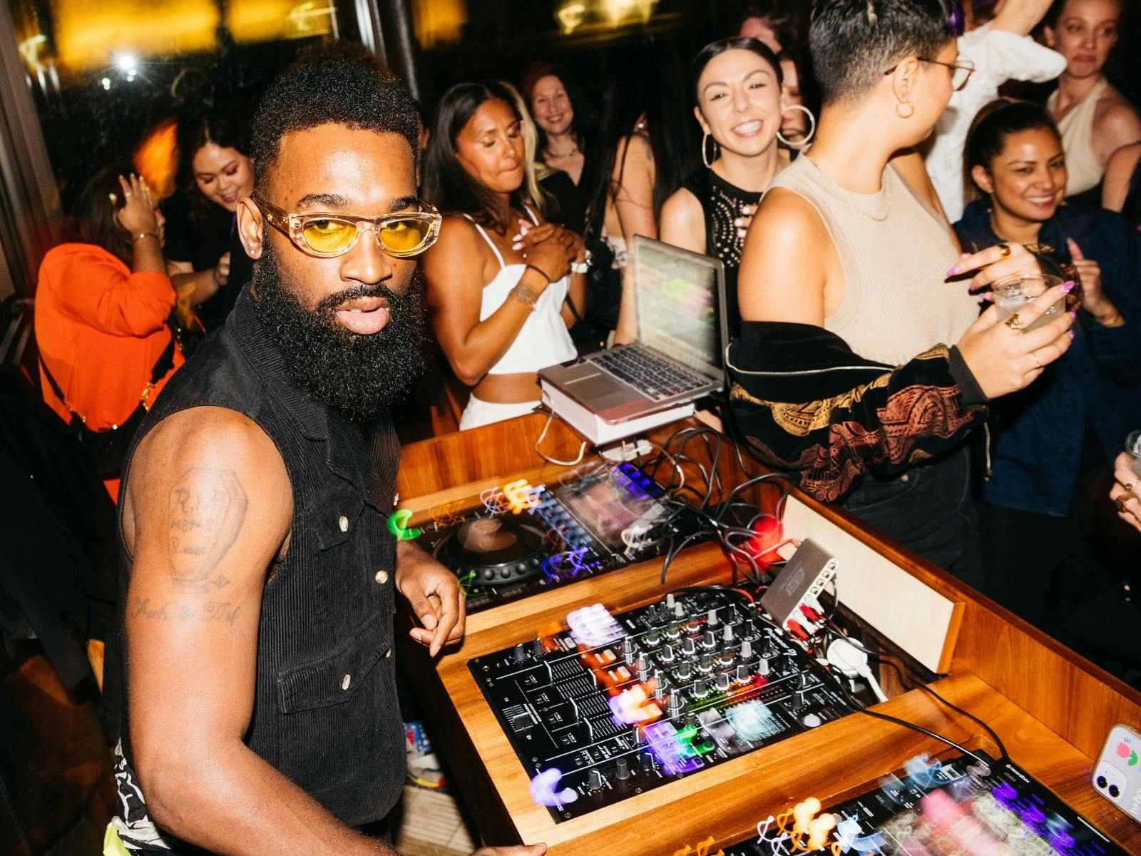 DJ surrounded by people