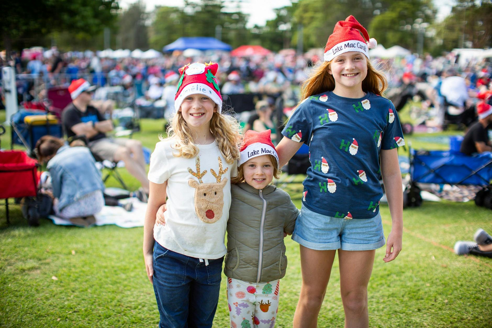 Children with Santa hats on celebrating Carols