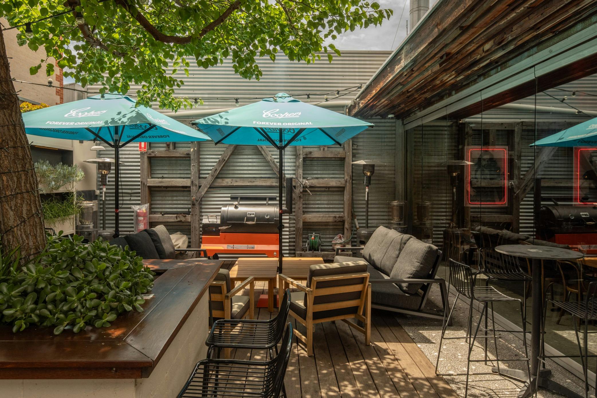 Relax under the shade in the Saracen's Head vibrant outdoor area, perfect for casual gatherings.