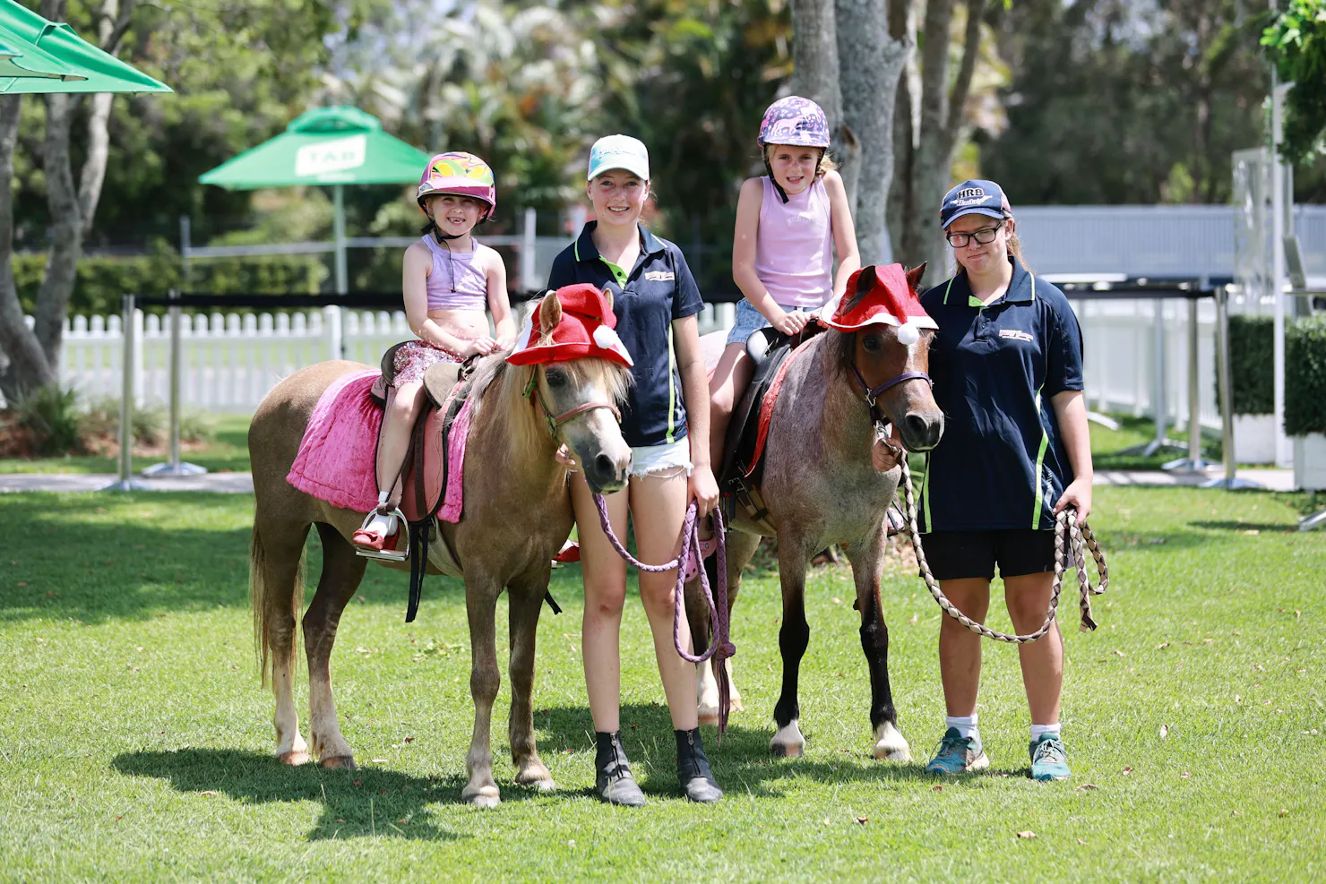 two young girls riding the ponies