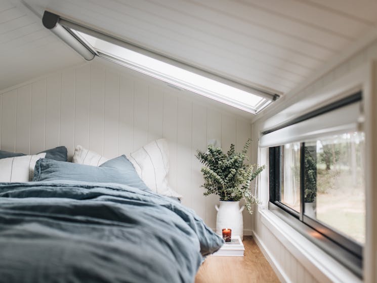 queen bed in loft of the tiny house