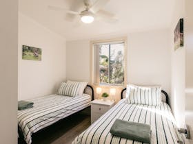 Twin bedroom at Beachside with fan