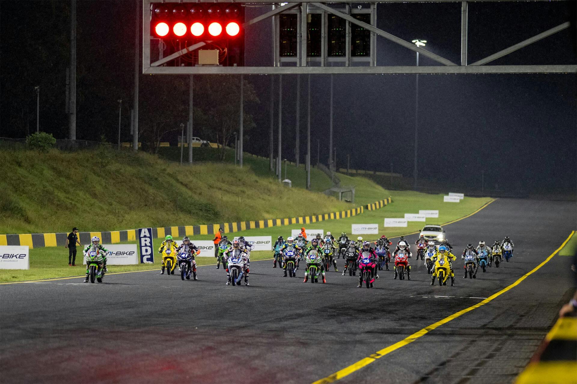 Attendees walking through the open pitlane
