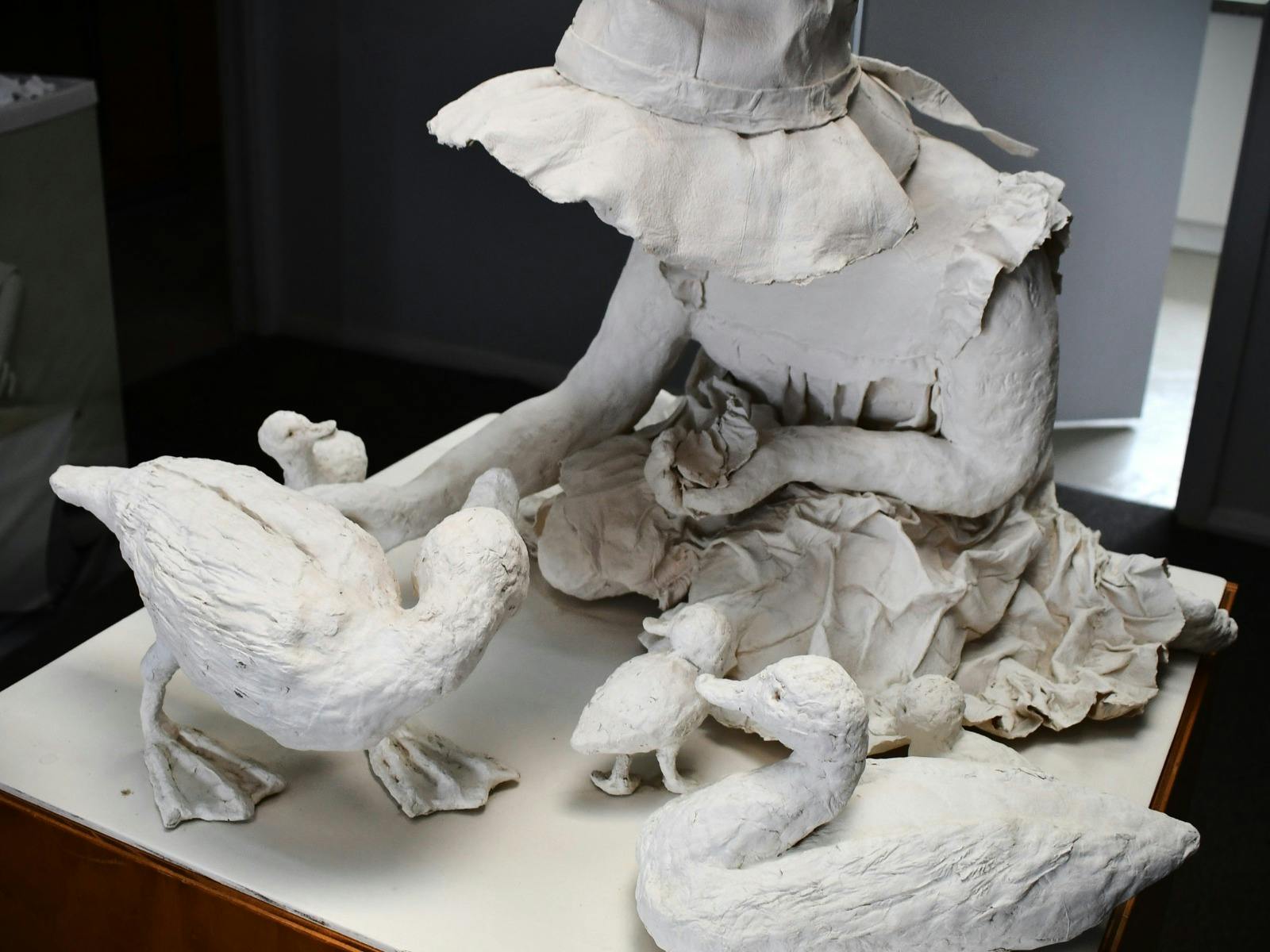 Paper Mache sculpture, little girl feeding ducks.