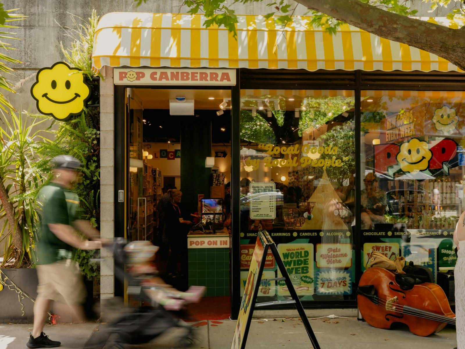 The exterior of POP Canberra, featuring its bright yellow awning, inviting signage, and good vibes.