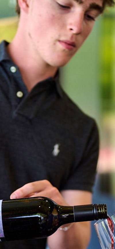 A winemaker serves wine at the Canberra Cellar Door