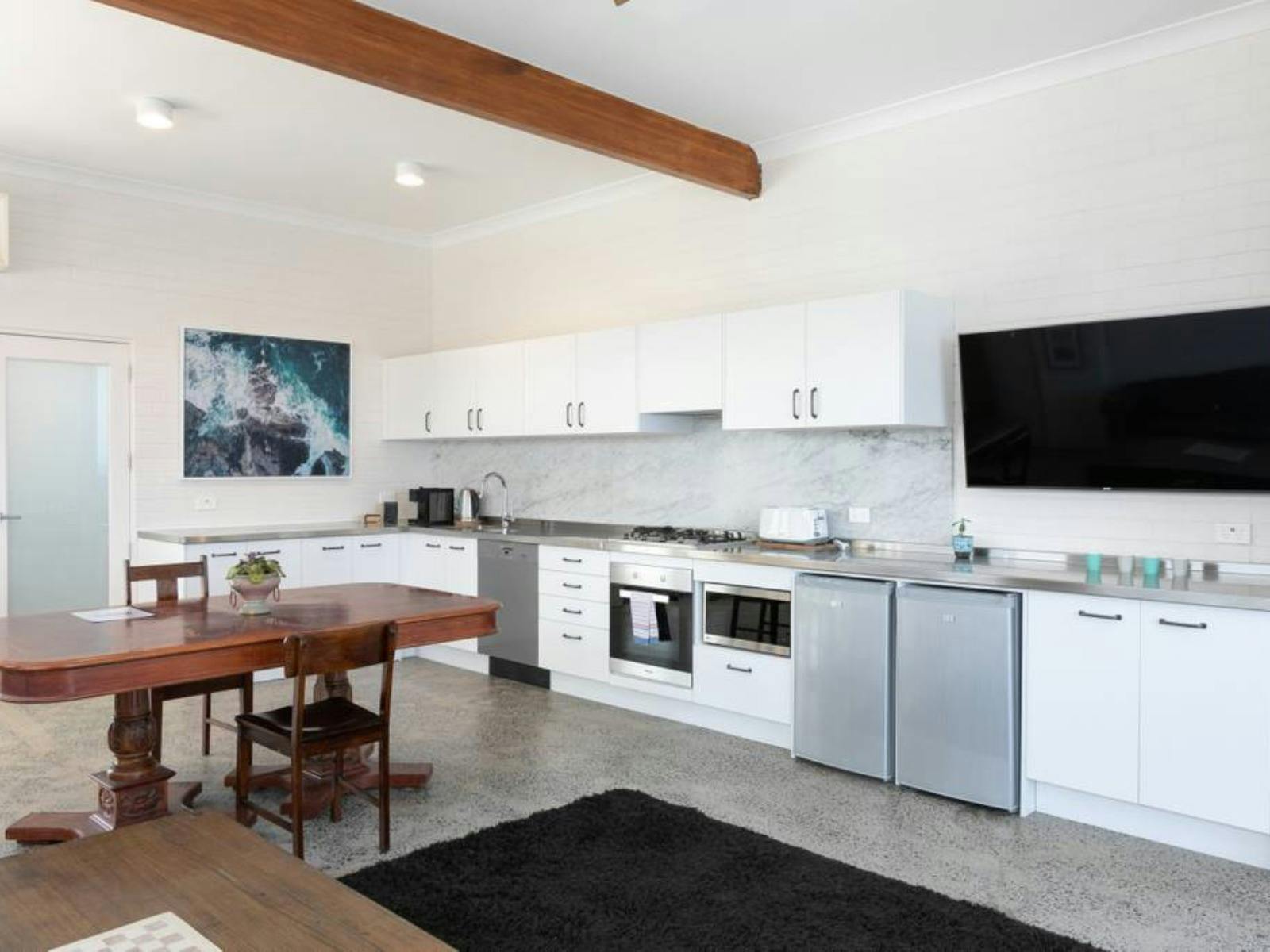 Open-plan living area with large windows showcasing stunning ocean views and natural light.