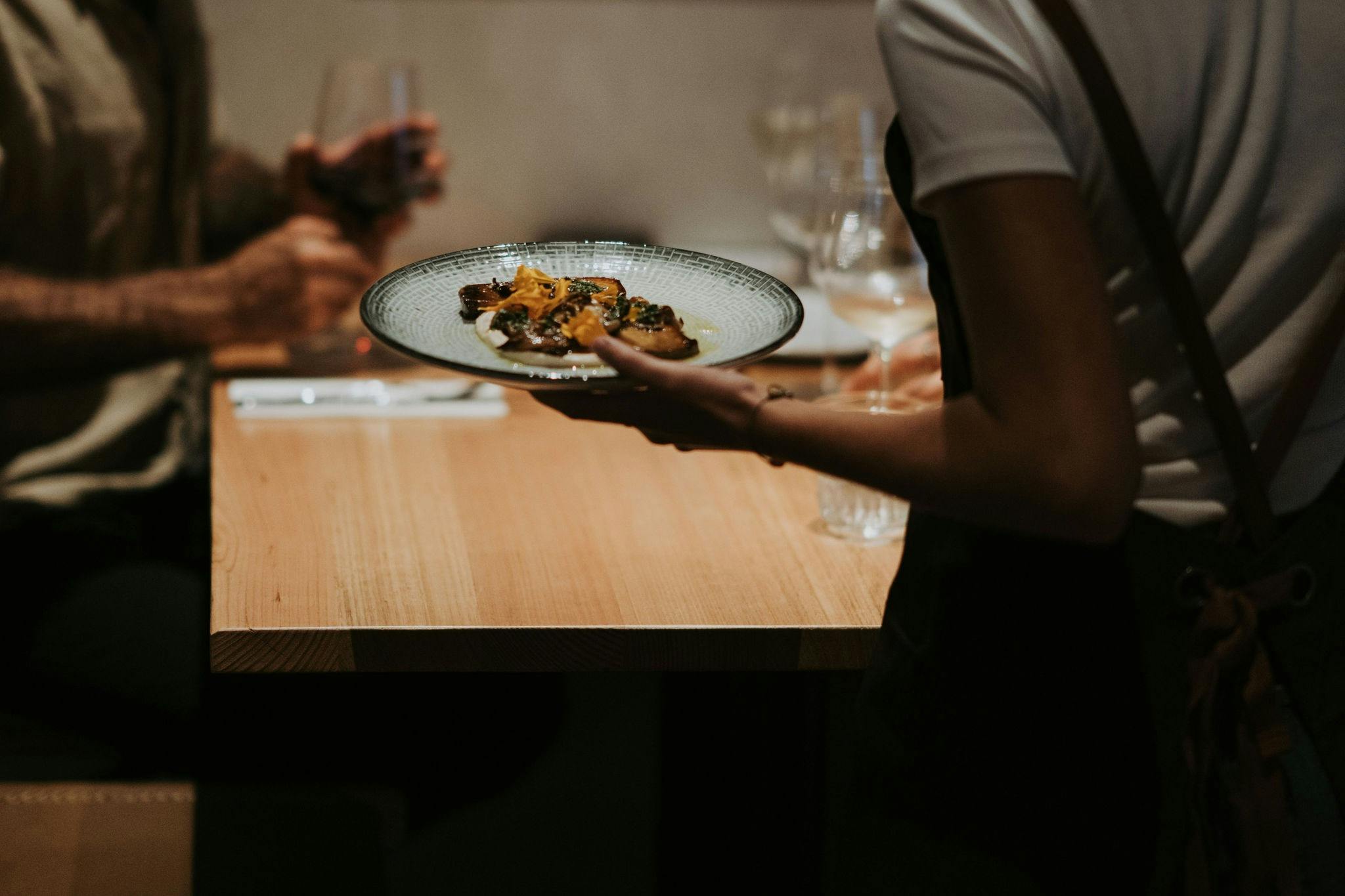 Delicious mushroom dish being served to one of the bar tables.
