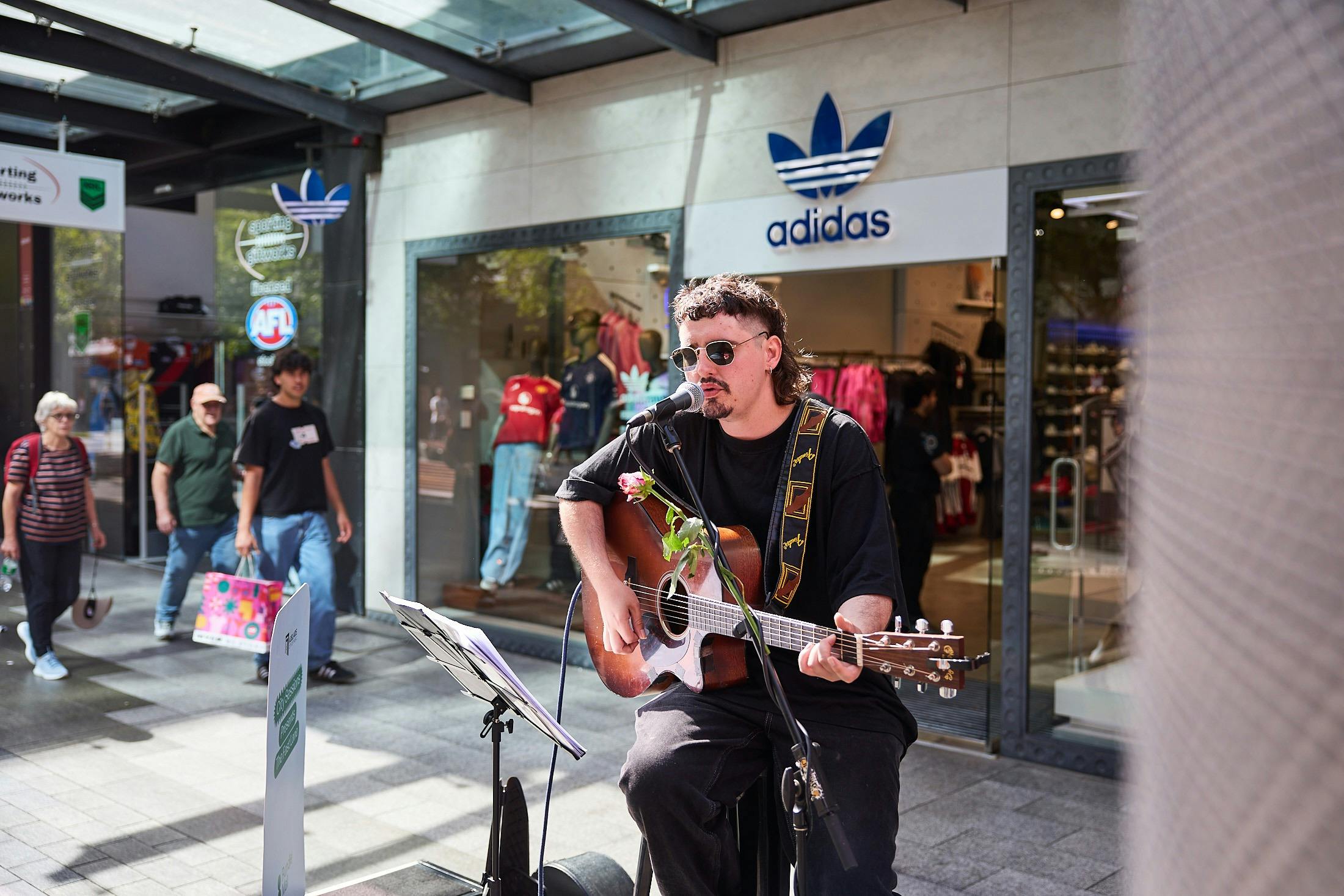 A young man playing the guitar and singing