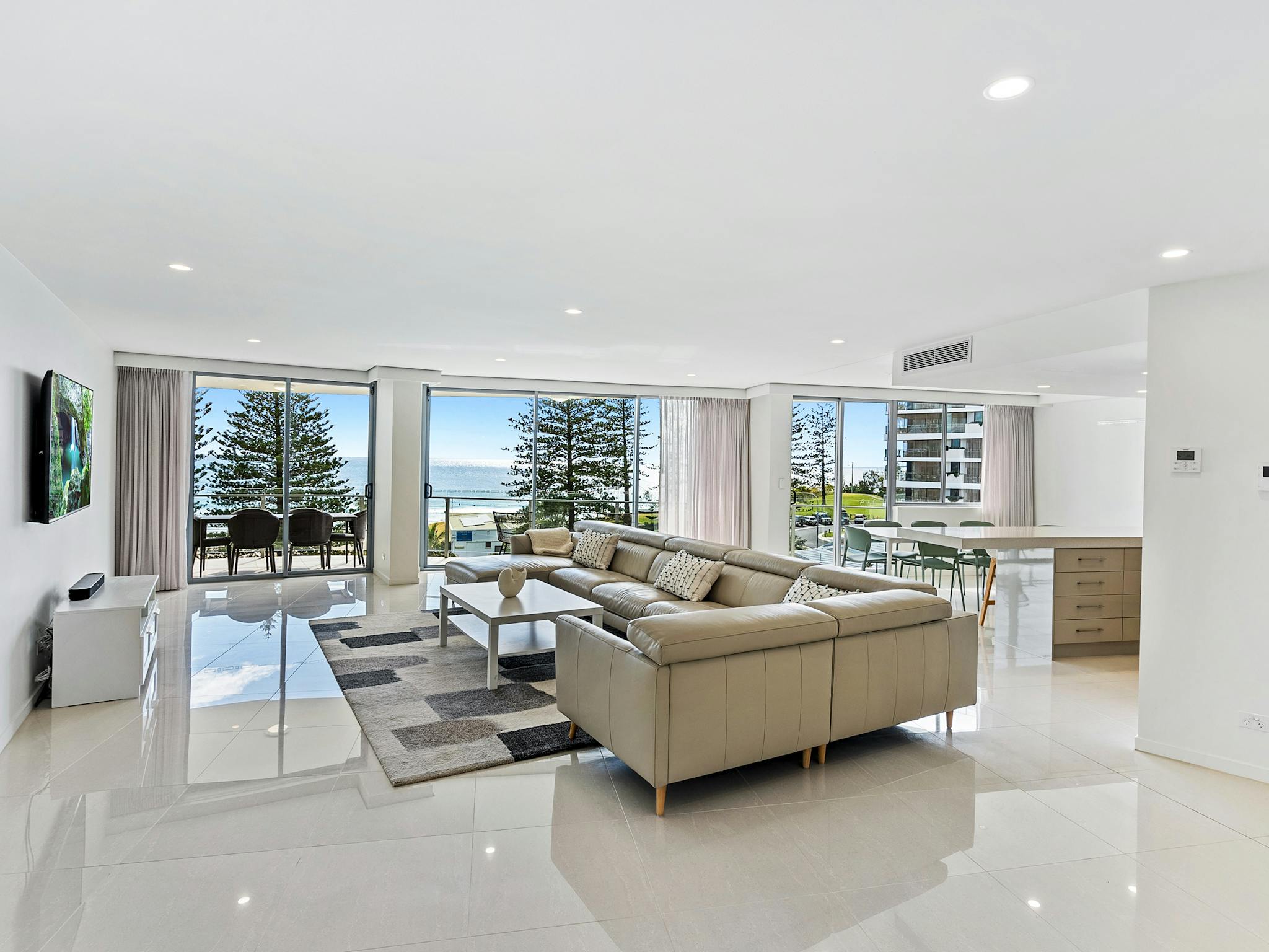Stylish lounge featuring a leather chaise lounge, high-gloss tiled floors, and stunning ocean views Stylish lounge featuring a leather chaise lounge, high-gloss tiled floors, and stunning ocean views