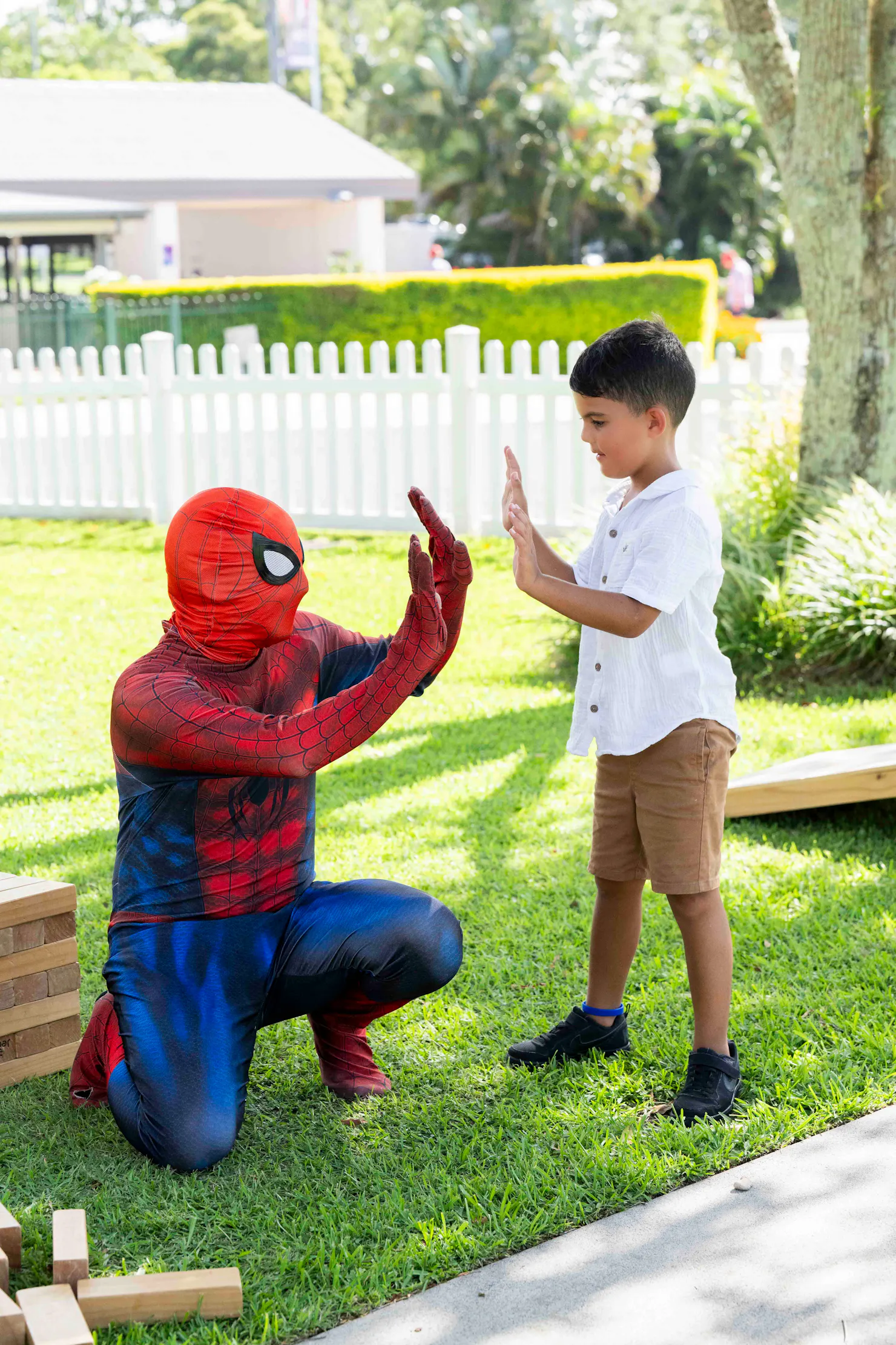 Young boy high fiving spiderman