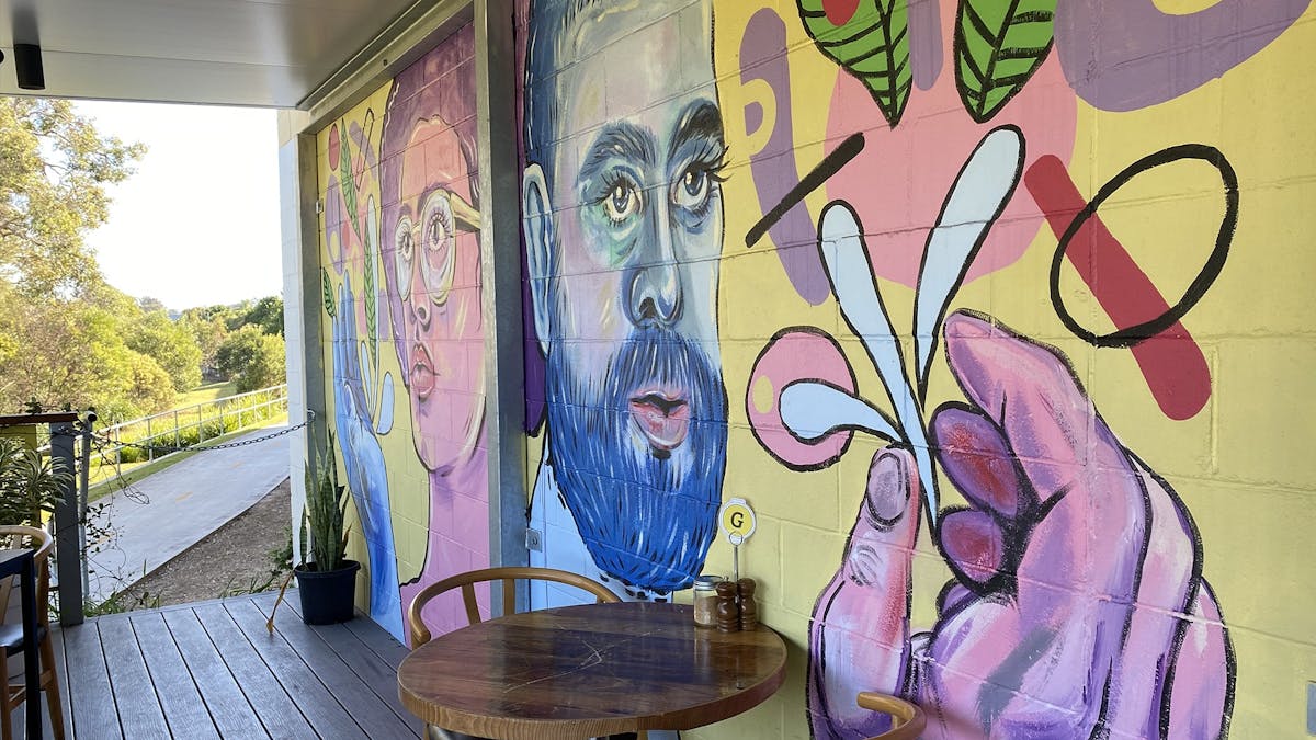 A brightly coloured mural on the deck wall at Extraction Artisan Coffee