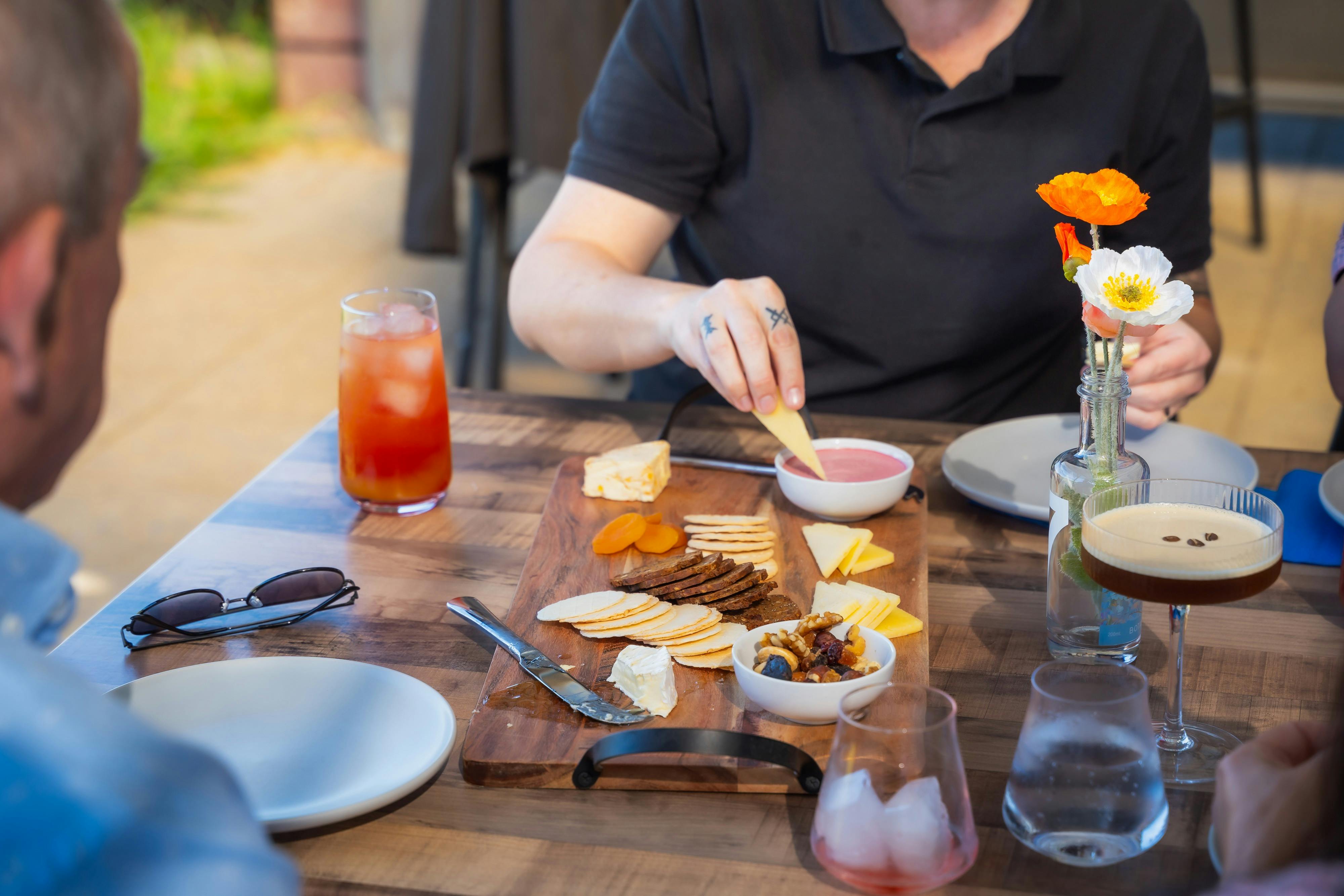 Cheese platter and cocktails enjoyed at AmberChes Spirits Distillery