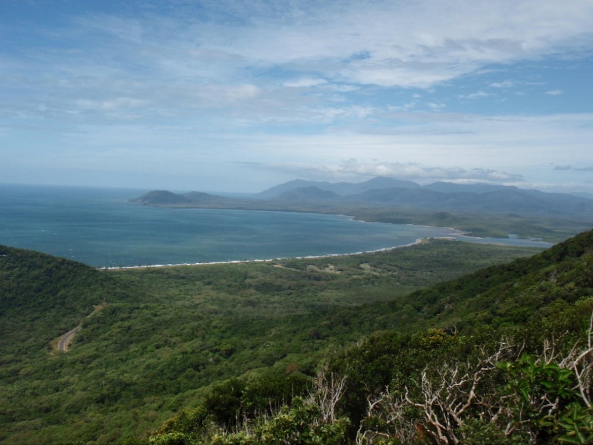 Coastline showing bay, mouth of Annan River and mountain range in the background.