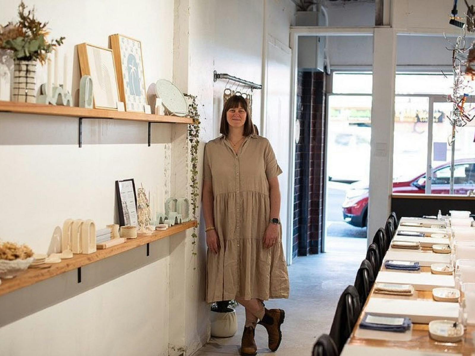 Victoria in her shop showcasing beautiful local art creations