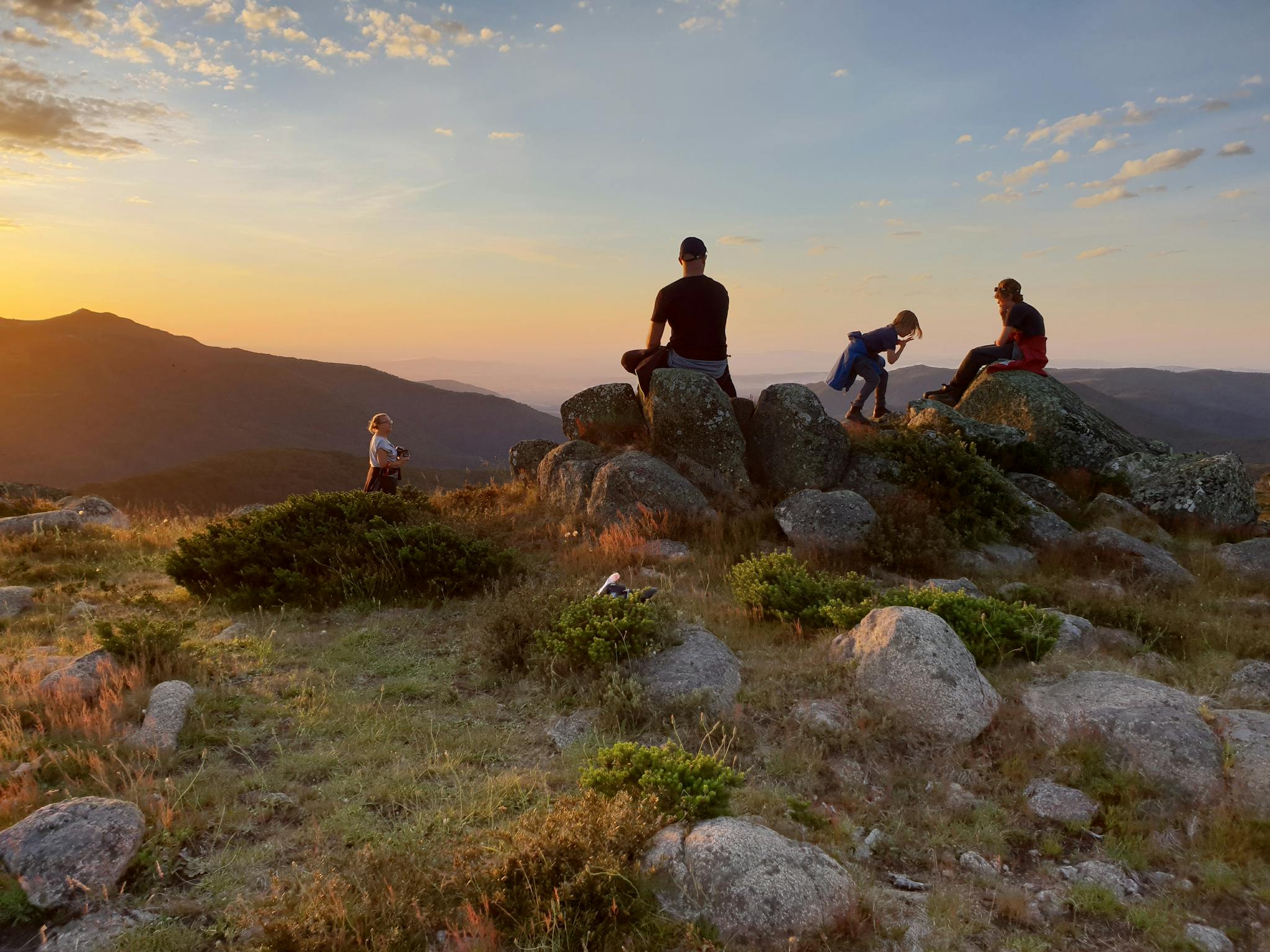 A family with young children watching sunset from Mt Stirling.