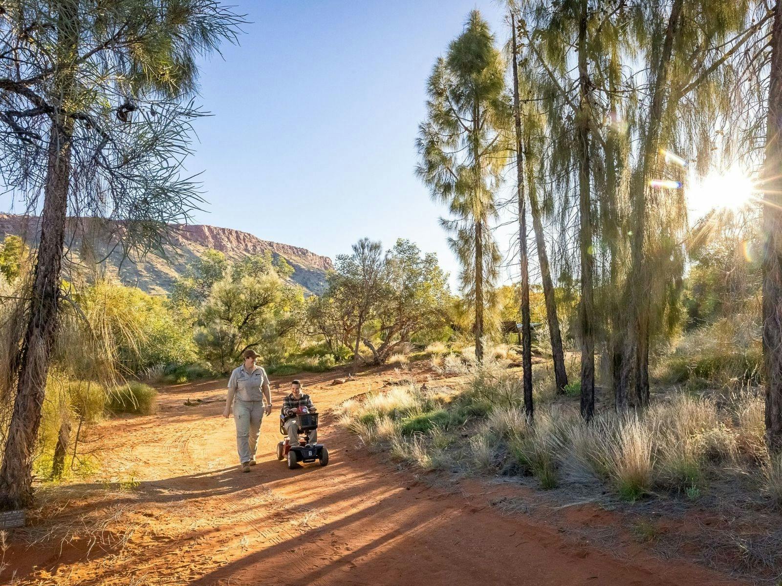 Desert Park guide with visitor using mobility scooter